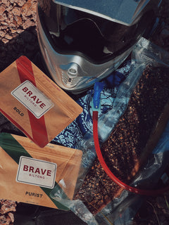 Motorcycle helmet with two packs of Brave Biltong on a Brave Bandana